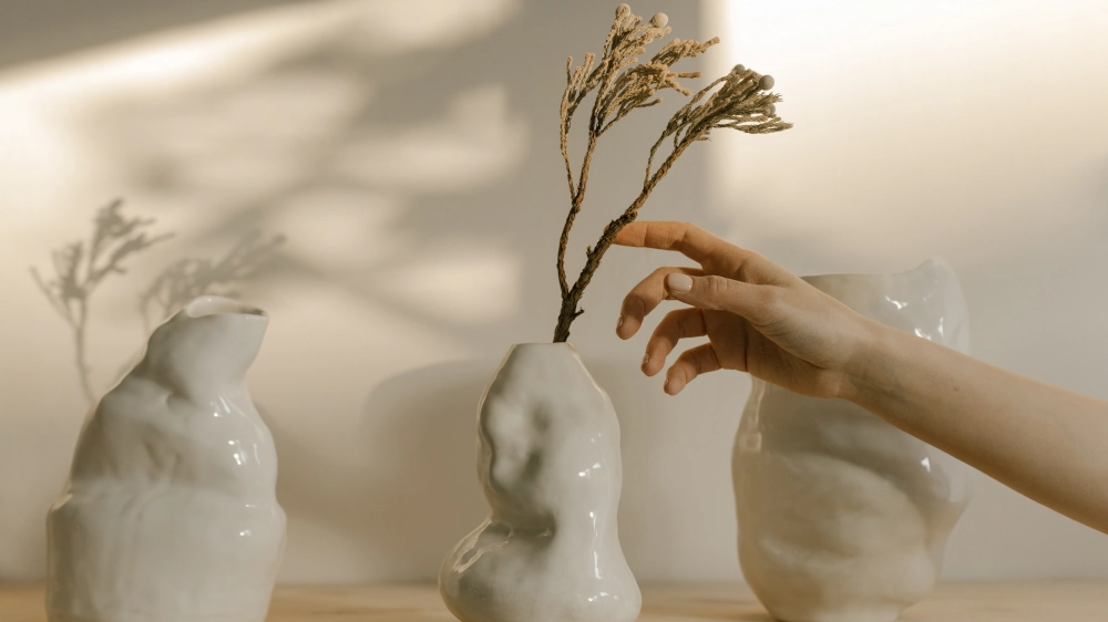 花瓶の植物に触れる手